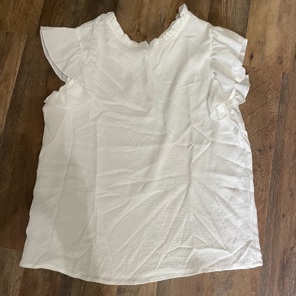 White blouse with ruffle sleeve and neckline